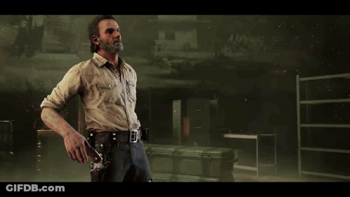 A Man With A Beard Is Holding A Gun In His Right Hand GIF