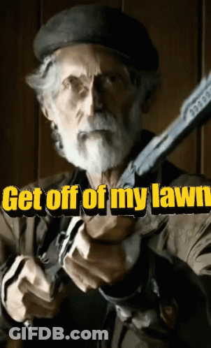 A Man With A Beard Is Holding A Gun With The Words Get Off Of My Lawn Behind Him GIF