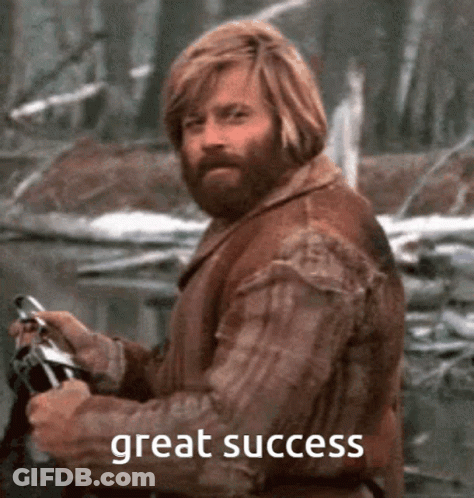 A Man With A Beard Is Holding A Gun With The Words Great Success Written Below Him GIF