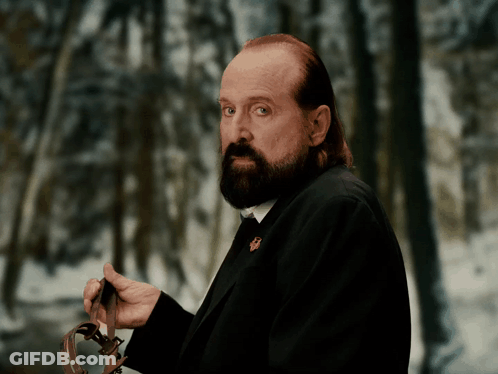 A Man With A Beard Is Holding A Leash In His Hands GIF