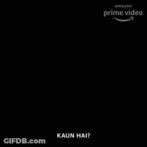 A Man With A Beard Is Holding A Lit Candle In His Hand And Says Kaun Hai GIF