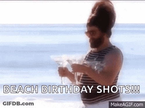 A Man With A Beard Is Holding A Martini On The Beach And Says Beach Birthday Shots . GIF
