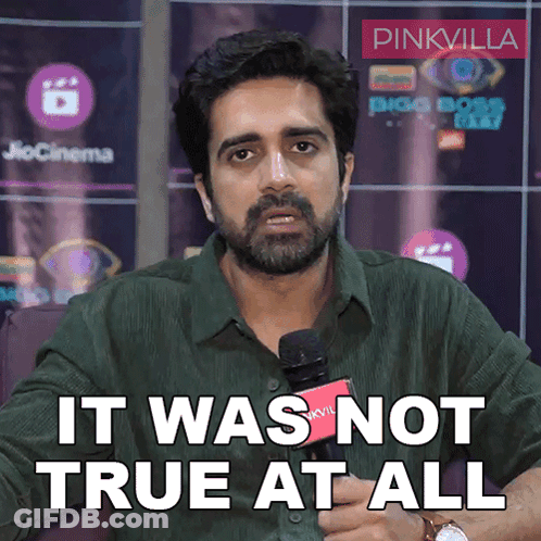 A Man With A Beard Is Holding A Microphone And Saying It Was Not True At All GIF