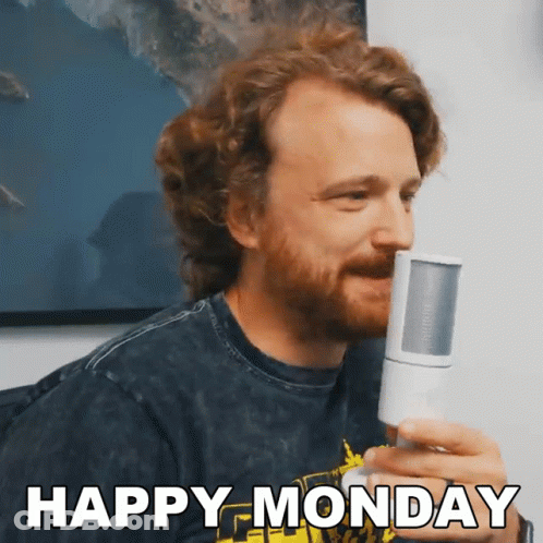 A Man With A Beard Is Holding A Microphone And Says Happy Monday GIF