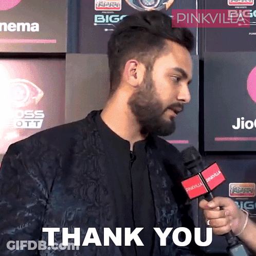 A Man With A Beard Is Holding A Microphone That Says Thank You GIF