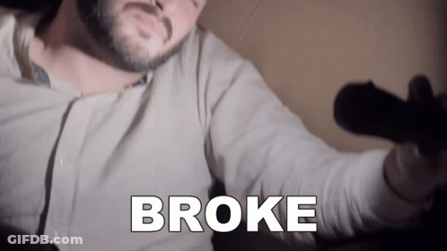 A Man With A Beard Is Holding A Microphone With The Word Broke Written On It GIF