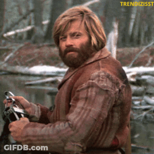 Man With Beard Holding Binoculars In Front Of Trendzisst Logo GIF