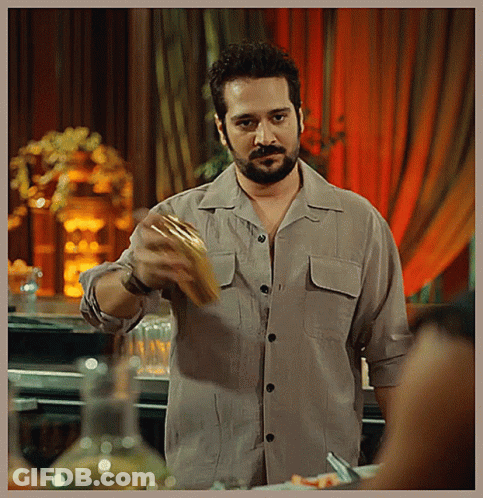 A Man With A Beard Is Holding A Piece Of Food GIF