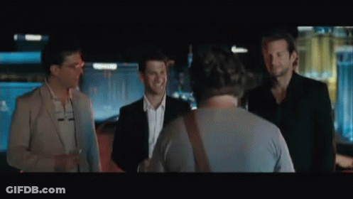 A Man With A Beard Is Holding A Piece Of Paper In Front Of A Casino . GIF