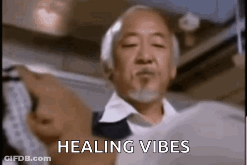 A Man With A Beard Is Holding A Piece Of Paper In His Hand And Says `` Healing Vibes '' . GIF