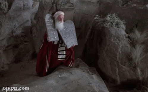 A Man With A Beard Is Holding A Plaque With The Words Has Given Unto You Written On It GIF