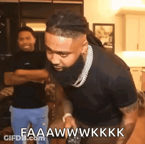 A Man With A Beard Is Holding A Remote Control And Says Faaawwkkk GIF