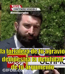 A Man With A Beard Is Holding A Sign That Says Vivo GIF