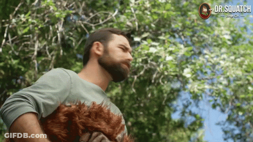 A Man With A Beard Is Holding A Stuffed Animal That Says Dr Squatch GIF