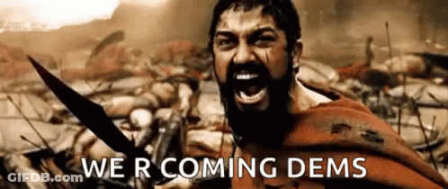 A Man With A Beard Is Holding A Sword And Screaming In A Battle Scene From The Movie 300 . GIF
