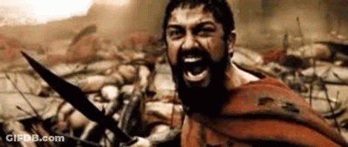 A Man With A Beard Is Holding A Sword In Front Of A Crowd Of Soldiers . GIF