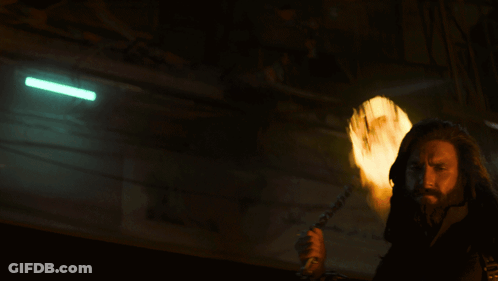 A Man With A Beard Is Holding A Torch In His Hand GIF
