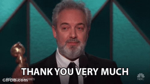A Man With A Beard Is Holding A Trophy And Saying Thank You Very Much GIF