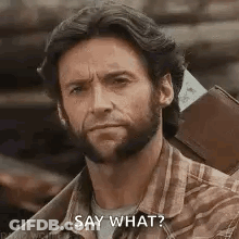 A Man With A Beard Is Holding A Wallet And A Ticket And Saying `` Say What '' . GIF