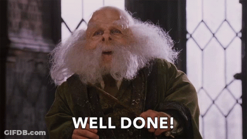 A Man With A Beard Is Holding A Wand And The Words Well Done Are Above Him GIF