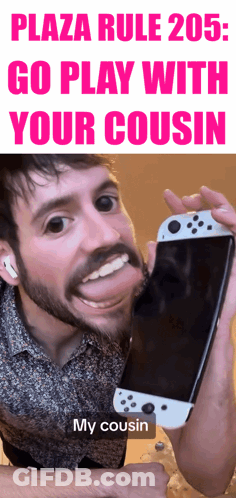A Man With A Beard Is Holding A White Nintendo Switch In His Hand GIF