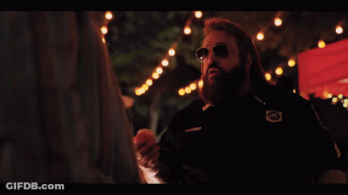 A Man With A Beard Is Holding An Apple And The Words Trick Or Treat Are Below Him GIF