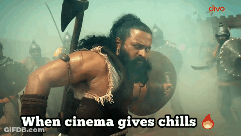 A Man With A Beard Is Holding An Axe And Shield With The Words When Cinema Gives Chills Below Him GIF