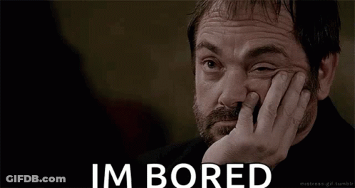 A Man With A Beard Is Holding His Hand To His Face And Says Im Bored GIF