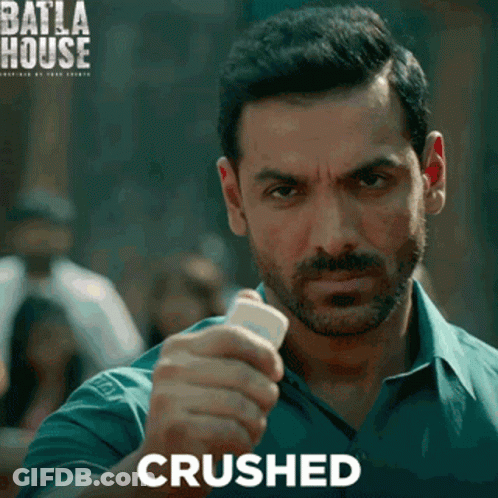 A Man With A Beard Is Holding Something In His Hand And The Word Crushed Is On The Bottom GIF