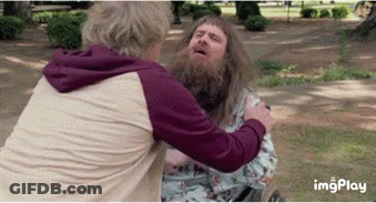 A Man With A Beard Is Hugging Another Man GIF