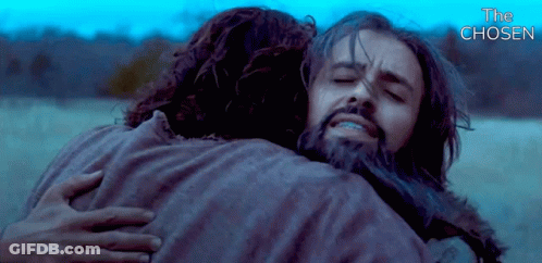 A Man With A Beard Is Hugging Another Man With The Words " The Chosen " Above Them GIF