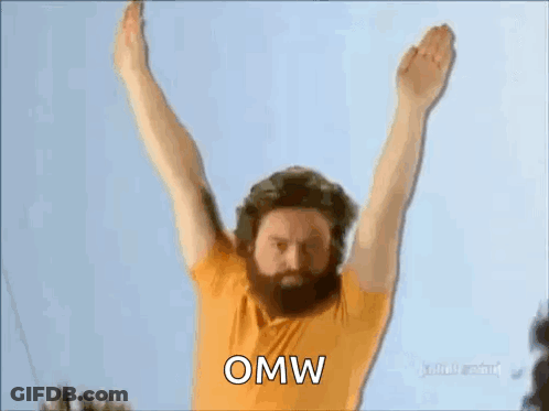 A Man With A Beard Is Jumping In The Air With His Arms Outstretched And The Word Omw Written On The Screen . GIF