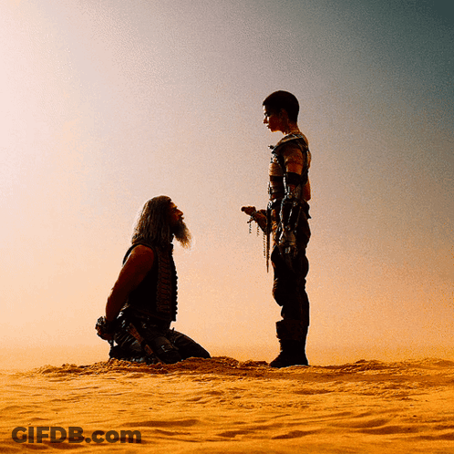 A Man With A Beard Is Kneeling Down In The Desert GIF
