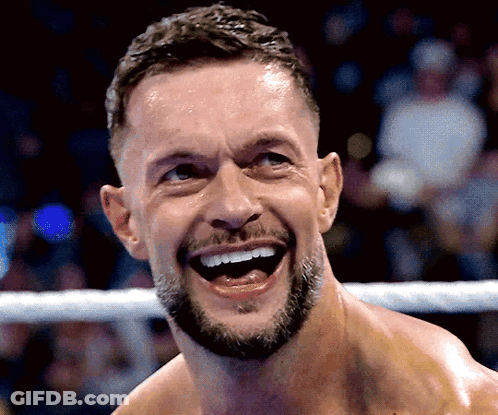A Man With A Beard Is Laughing In A Boxing Ring GIF