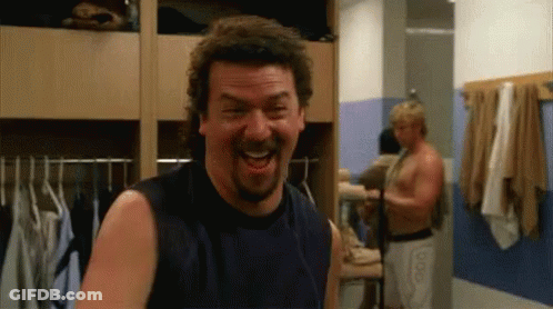 A Man With A Beard Is Laughing In A Dressing Room GIF