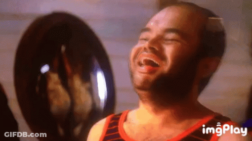 A Man With A Beard Is Laughing In Front Of A Fan With Imgplay Written On The Bottom GIF