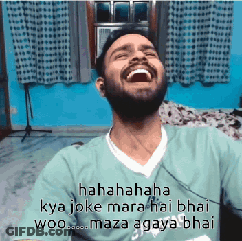 A Man With A Beard Is Laughing While Wearing A Green Shirt That Says Adidas On It GIF