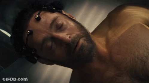 A Man With A Beard Is Laying In A Bathtub With Wires Around His Head GIF