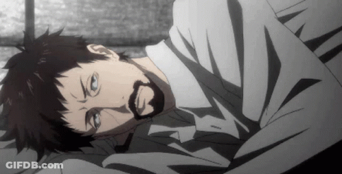 A Man With A Beard Is Laying On A Bed With His Eyes Closed GIF