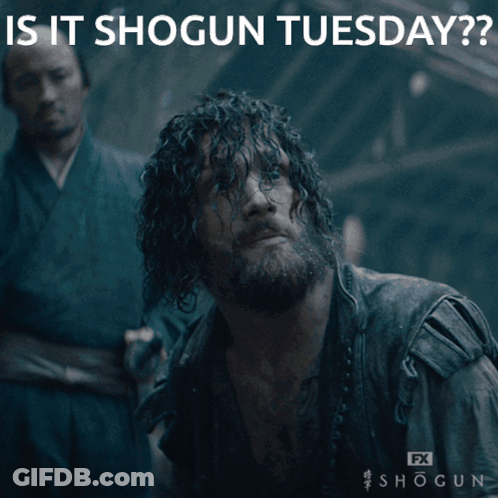 A Man With A Beard Is Laying On The Ground With The Caption " Is It Shogun Tuesday " Above Him GIF