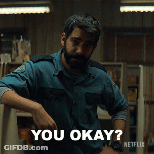 A Man With A Beard Is Leaning Against A Counter And Says You Okay GIF