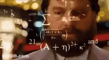 A Man With A Beard Is Looking At A Computer Screen With Mathematical Equations Coming Out Of It . GIF