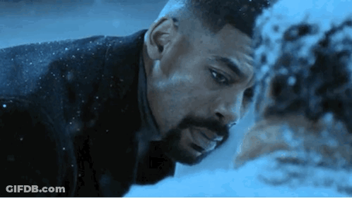 A Man With A Beard Is Looking At Another Man 'S Face In The Snow . GIF