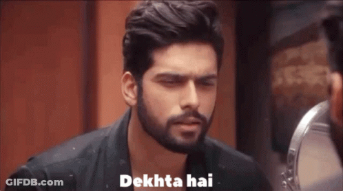 A Man With A Beard Is Looking At Himself In A Mirror And Saying Dekhta Hai . GIF