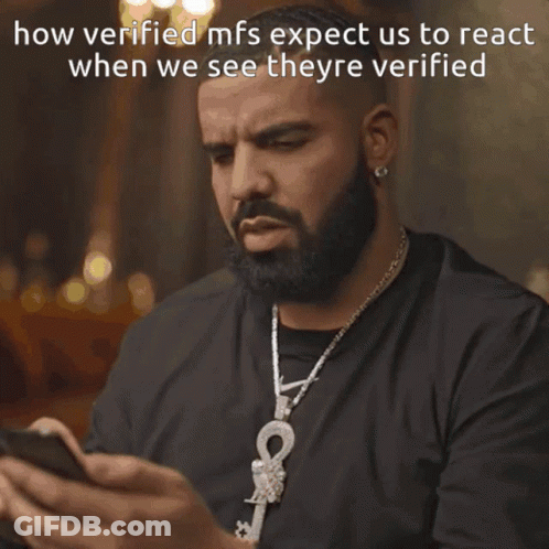 A Man With A Beard Is Looking At His Phone With The Words Wow Written Below Him GIF