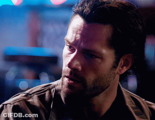 A Man With A Beard Is Looking At Something GIF