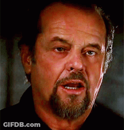 A Man With A Beard Is Looking At The Camera GIF