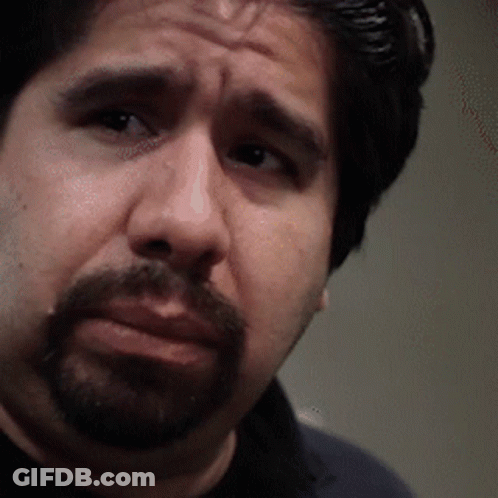 A Man With A Beard Is Looking At The Camera With A Serious Look On His Face GIF