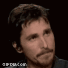 A Man With A Beard Is Looking At The Camera With A Serious Look On His Face GIF