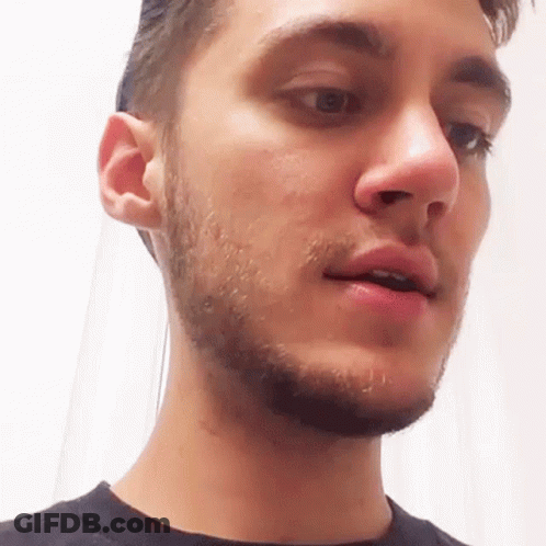 A Man With A Beard Is Looking At The Camera With His Mouth Open GIF